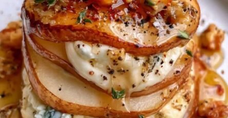 Elegant rustic tower layered Gorgonzola Pear creamy blue cheese filling, toasted walnuts, honey drizzle, fresh thyme, and cracked black pepper.