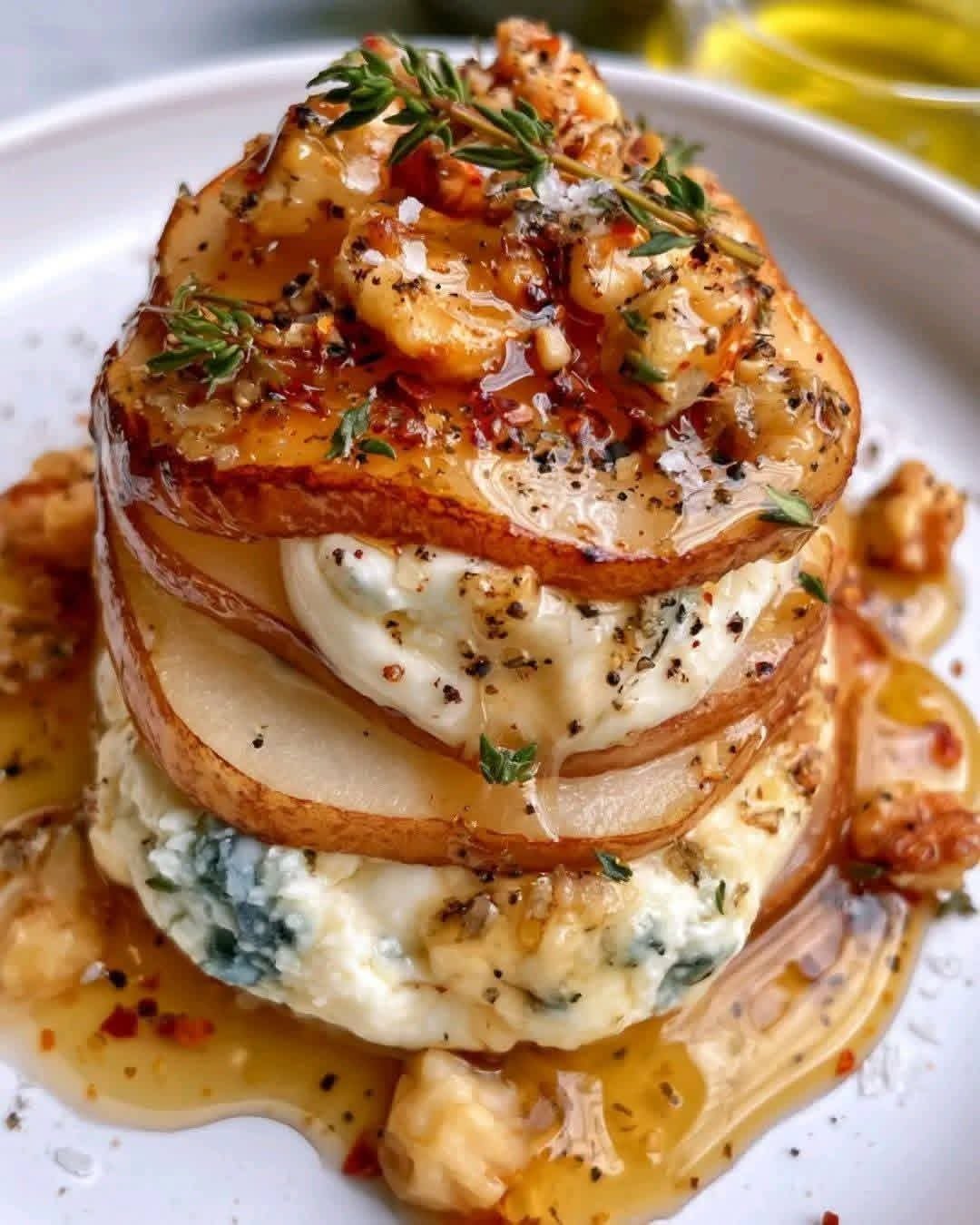 Elegant rustic tower layered Gorgonzola Pear creamy blue cheese filling, toasted walnuts, honey drizzle, fresh thyme, and cracked black pepper.