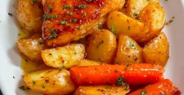 Honey Garlic Roasted Chicken with Crispy Potatoes and Sweet Roasted Carrots on a White Serving Platter