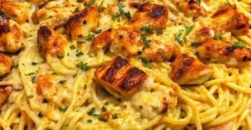 Creamy Monterey Jack chicken spaghetti topped with golden seasoned chicken pieces, melted cheese, and fresh parsley.