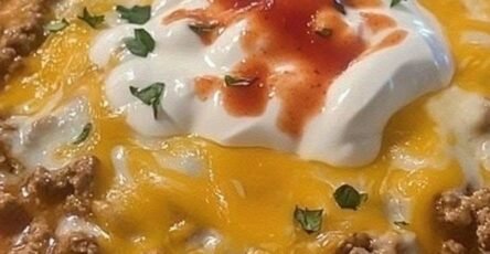 Creamy taco soup with ground beef, cheddar cheese, sour cream, tomatoes, and green chilies