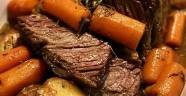Tender classic pot roast with carrots and potatoes in rich beef broth