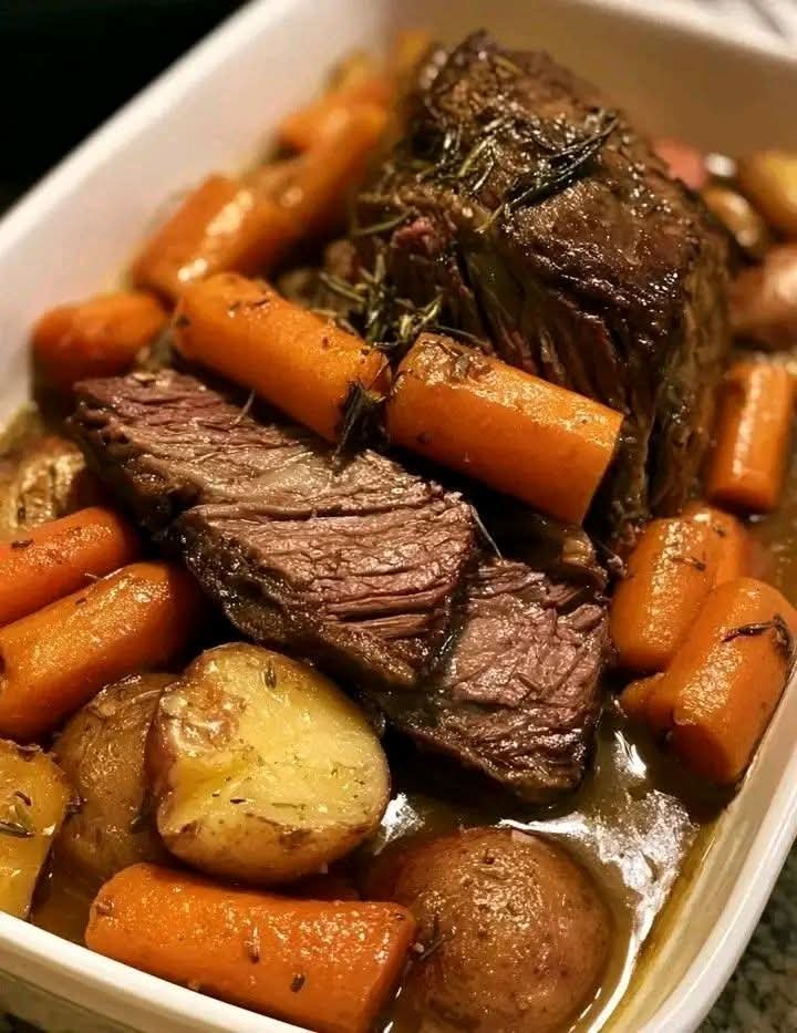 Tender classic pot roast with carrots and potatoes in rich beef broth