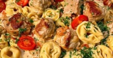 Creamy chicken tortellini with Parmesan garlic sauce, cherry tomatoes, and fresh parsley