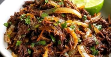 Crispy Cuban shredded beef with lime, garlic, caramelized onions, and fresh cilantro
