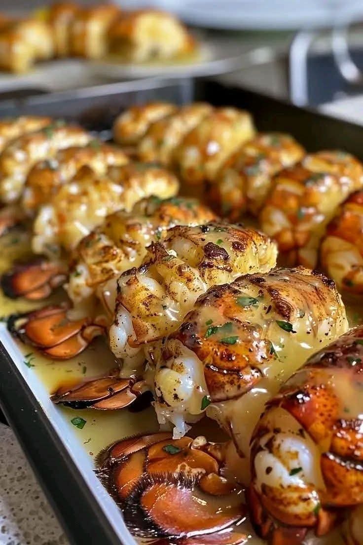 Baked lobster tails with creamy garlic butter, lemon, and fresh parsley