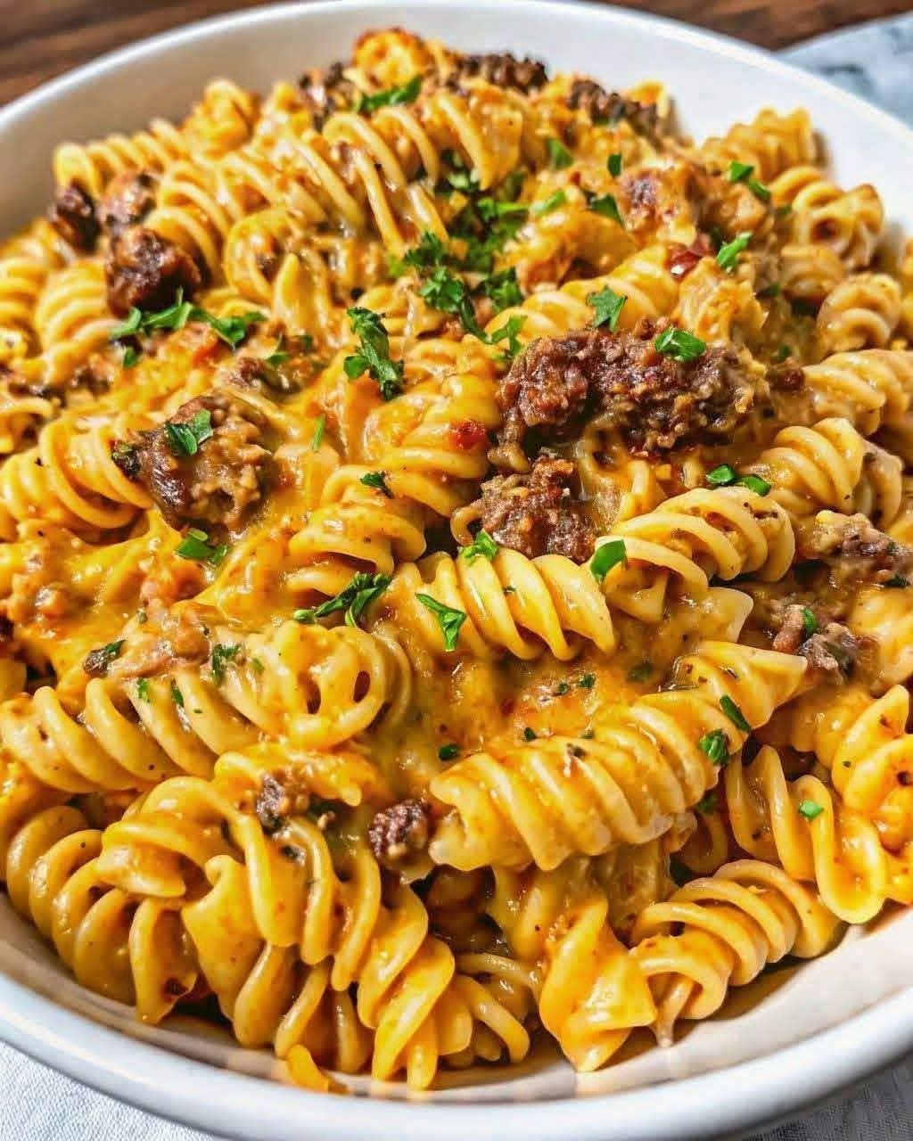 Creamy garlic beef rotini pasta with ground beef and cheddar cheese sauce
