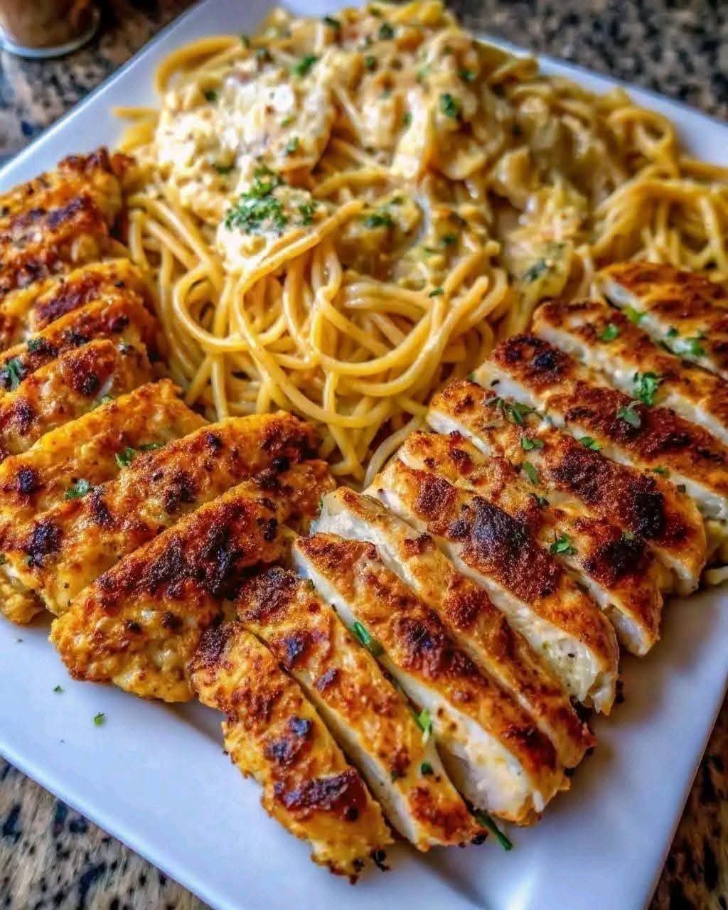 Garlic Parmesan chicken with creamy mozzarella spaghetti on a plate
