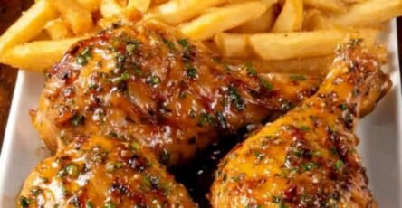 Glazed chicken leg quarters with crispy golden fries, fresh tomatoes, red onion, and creamy dipping sauce