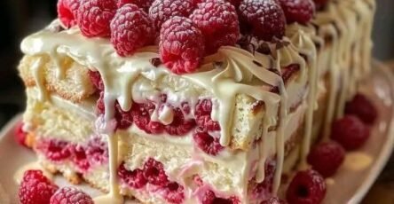 White chocolate raspberry cake with fresh raspberries and creamy white chocolate drizzle