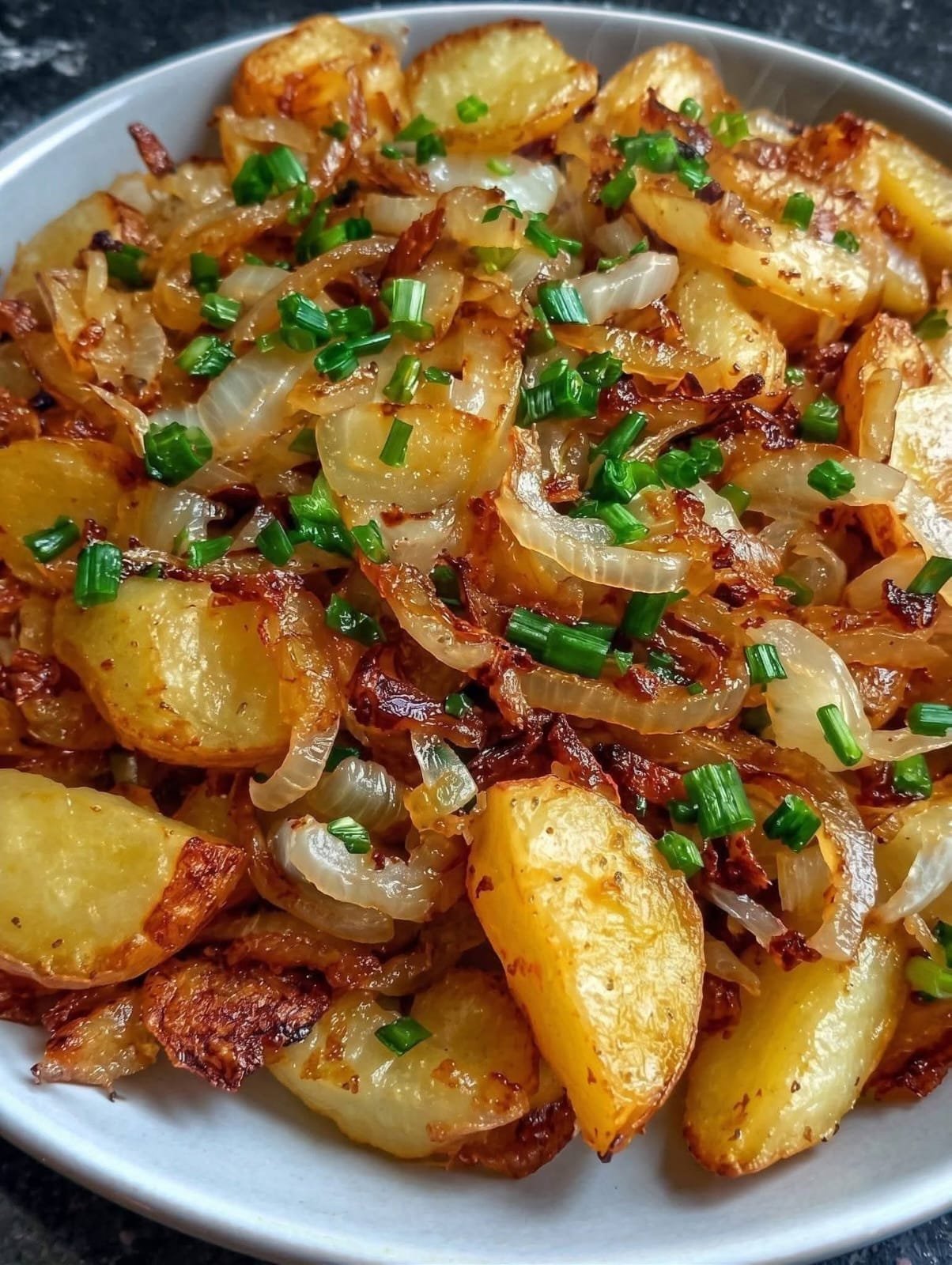 Crispy roasted potatoes with caramelized onions and green onions