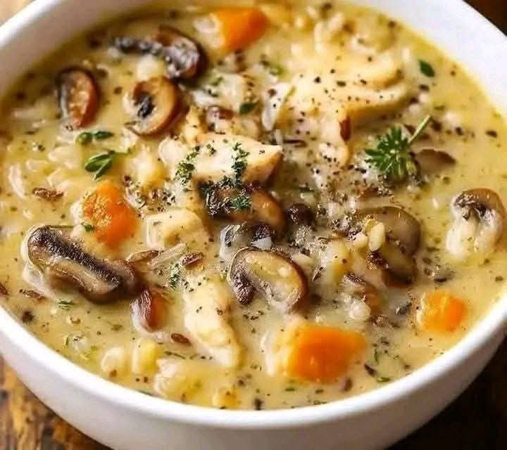 Creamy chicken mushroom wild rice soup with tender chicken, mushrooms, carrots, and herbs