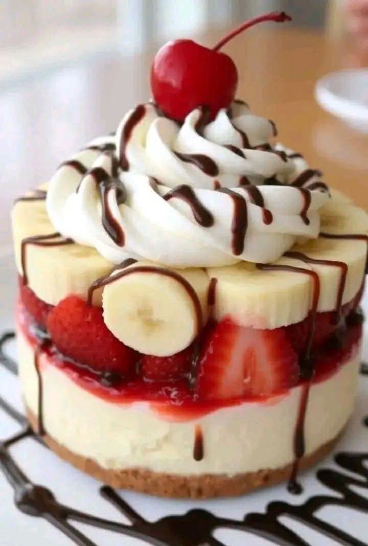 Mini strawberry banana desserts with Chantilly cream, whipped cream, chocolate syrup, and cherries