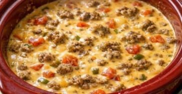 3-ingredient crockpot beef cheese dip with ground beef, melted cheese, tomatoes, and peppers