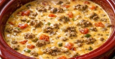 3-ingredient crockpot beef cheese dip with ground beef, melted cheese, tomatoes, and peppers