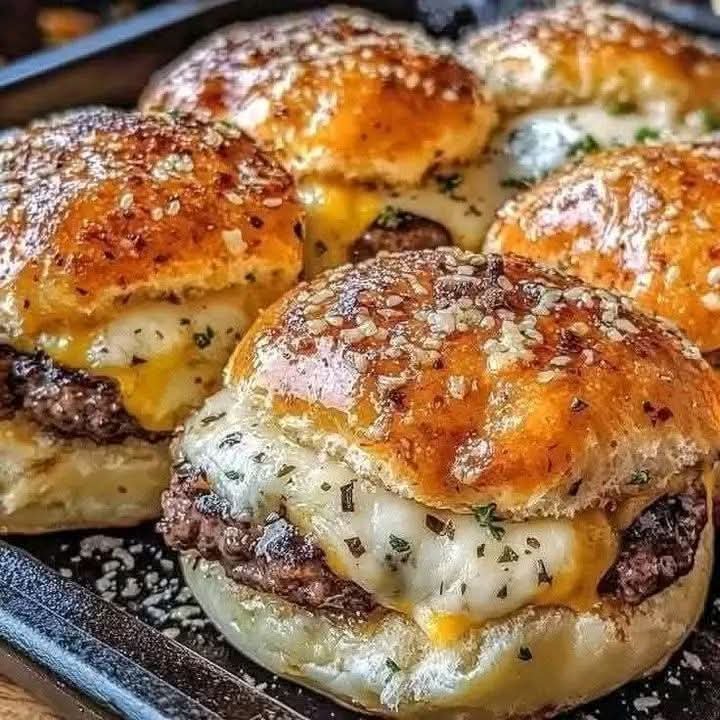 Garlic Parmesan cheeseburger bombs with seasoned beef, melted cheese, and golden sesame buns
