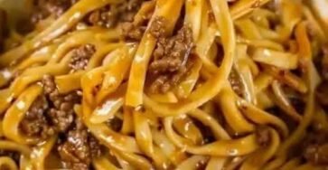 Bowl of savory ground beef noodles coated in a flavorful sauce