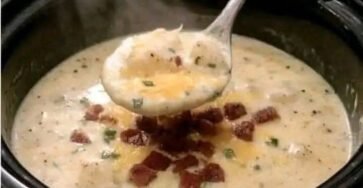 Creamy slow cooker loaded potato soup topped with crispy bacon and herbs